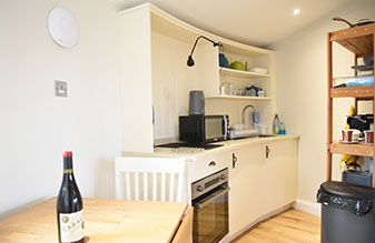 Our Self Catering accommodation kitchen contains oven microwave dining table